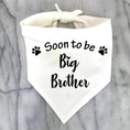Load image into Gallery viewer, Bandana pour chien blanc avec inscription Soon to be Big Brother et pattes noires