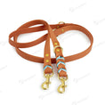 Load image into Gallery viewer, Laisse mains libres pour chien en cuir marron avec attaches métalliques dorées par Oscar et Plume