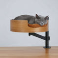 Load image into Gallery viewer, Lit design pour chat en bois fixé à une table avec coussin doux marron et chat gris allongé