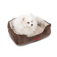 Load image into Gallery viewer, Lit pour chien très doux en velours marron avec petit chien blanc couché confortablement