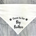 Load image into Gallery viewer, Bandana pour chien blanc avec inscription Soon to be Big Brother et motifs pattes noires

