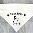 Load image into Gallery viewer, Bandana pour chien blanc avec l'inscription Soon to be Big Sister et motifs de pattes noires
