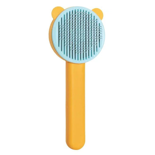 Brosse poils chat Oscar et Plume avec manche jaune et picots souples bleu clair pour toilettage