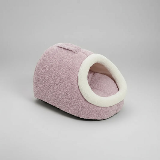 Cocon pour chat en peluche rose avec une ouverture ronde et un intérieur doux