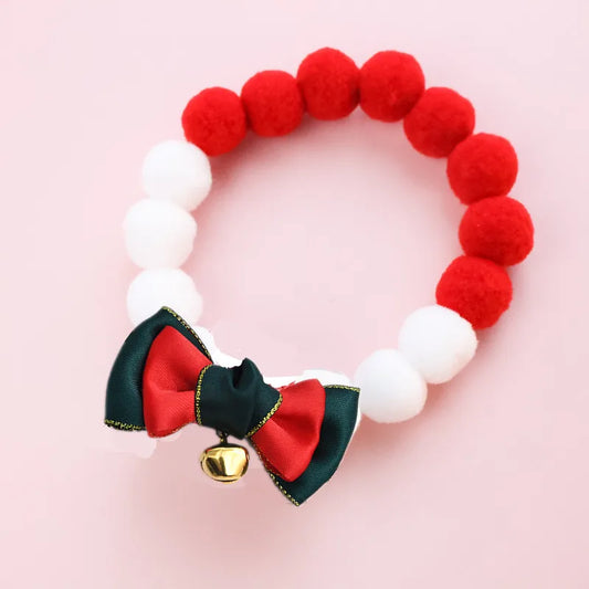 Collier de Noël pour chat et chien avec pompons rouges et blancs et un nœud décoratif