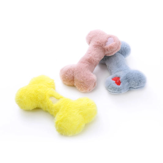 Jouet os en peluche pour chien en trois couleurs douces: jaune, rose et bleu, parfait pour les animaux de compagnie.