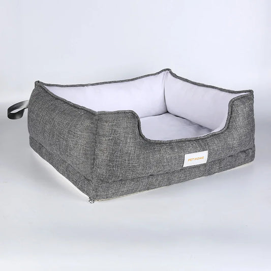 panier pour chien Oscar et Plume gris en tissu avec coussin blanc amovible et poignée pratique
