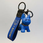 Porte-clés bouledogue bleu avec bracelet en tissu bleu et détails dorés tenu à la main