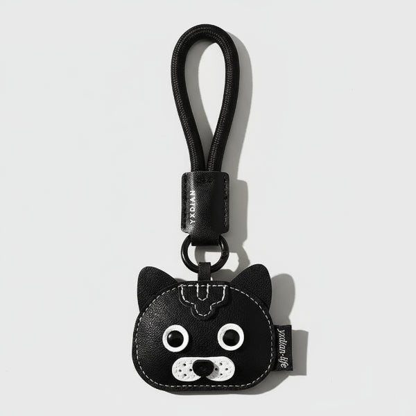 Porte-clés chien en cuir noir avec tête de chien stylisée et boucle pour attacher aux clés