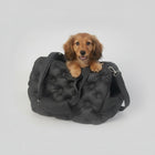 Sac de transport pour petit chien noir en tissu rembourré avec un chien à l'intérieur