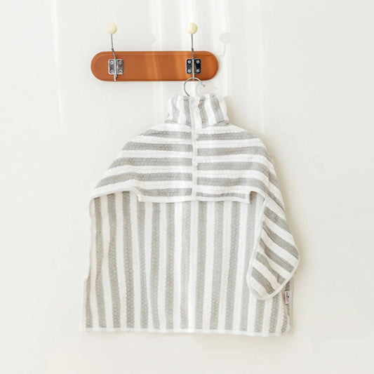 Serviette de bain chien à capuche rayée grise et blanche suspendue sur un crochet mural